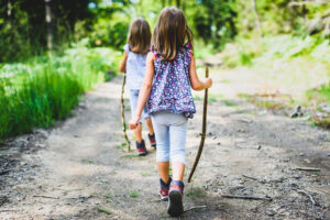 Children walking in the woods depicting cheap school holiday activity ideas